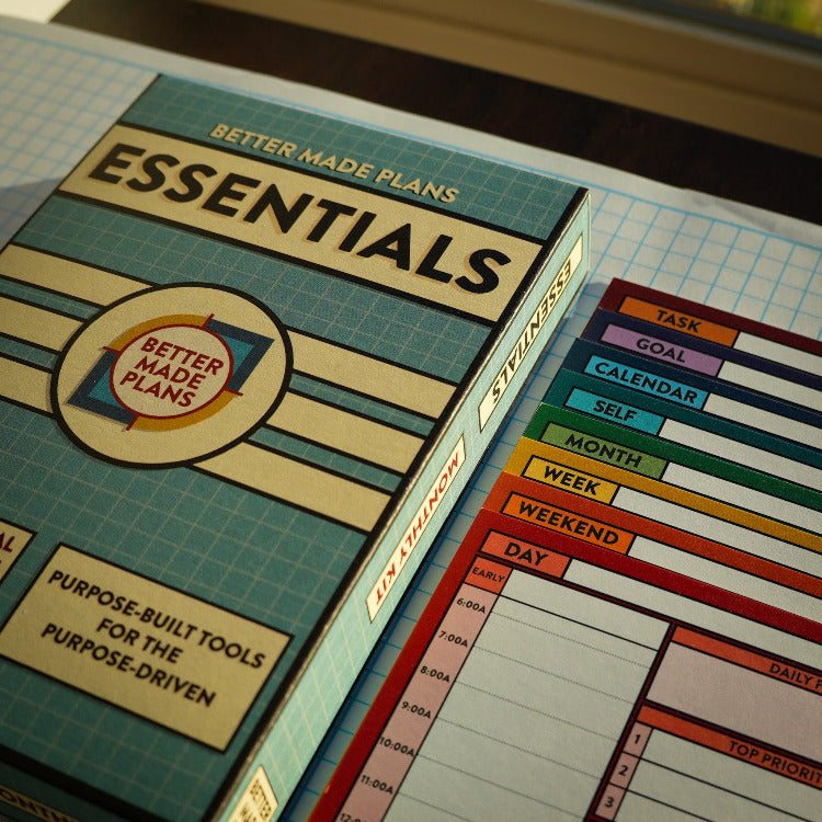 Product packaging for 'Better Made Plans Essentials' with a colorful planner on a grid background.