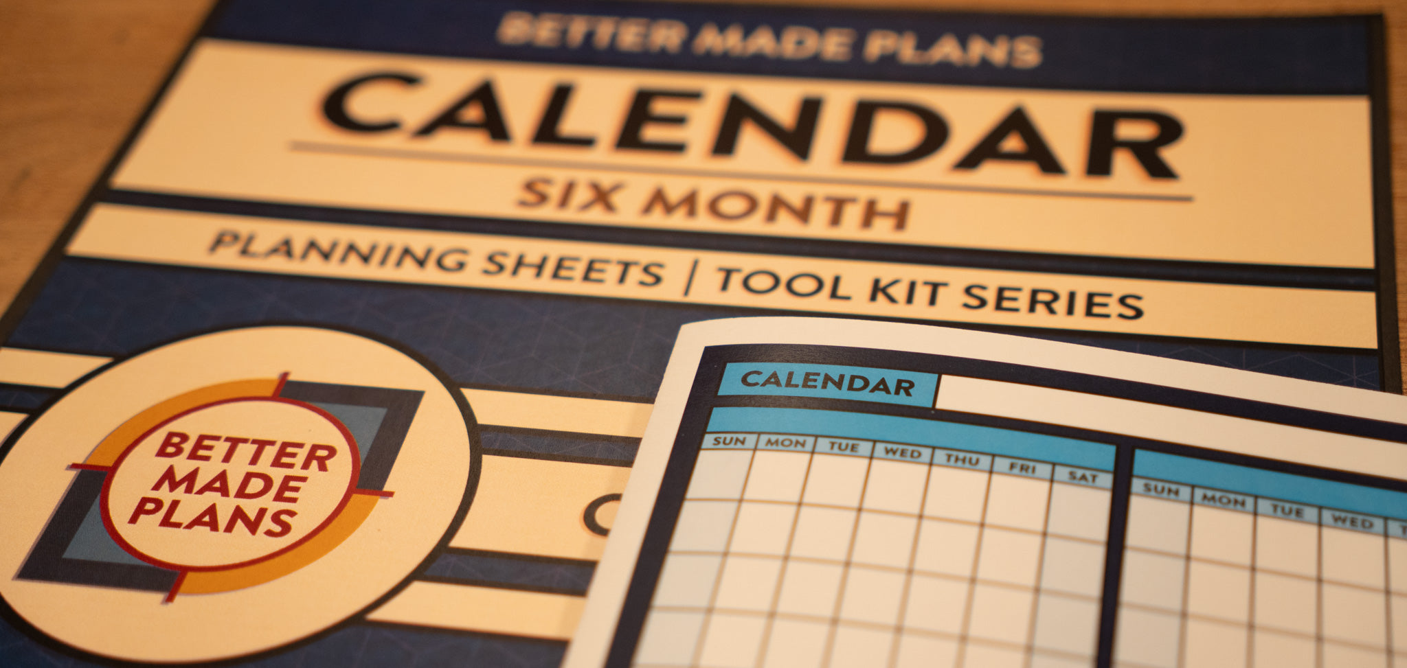 Picture of a printed Better Made Plans Planning Sheets series six month calendar laying on top of the cover for the Planning Sheet.