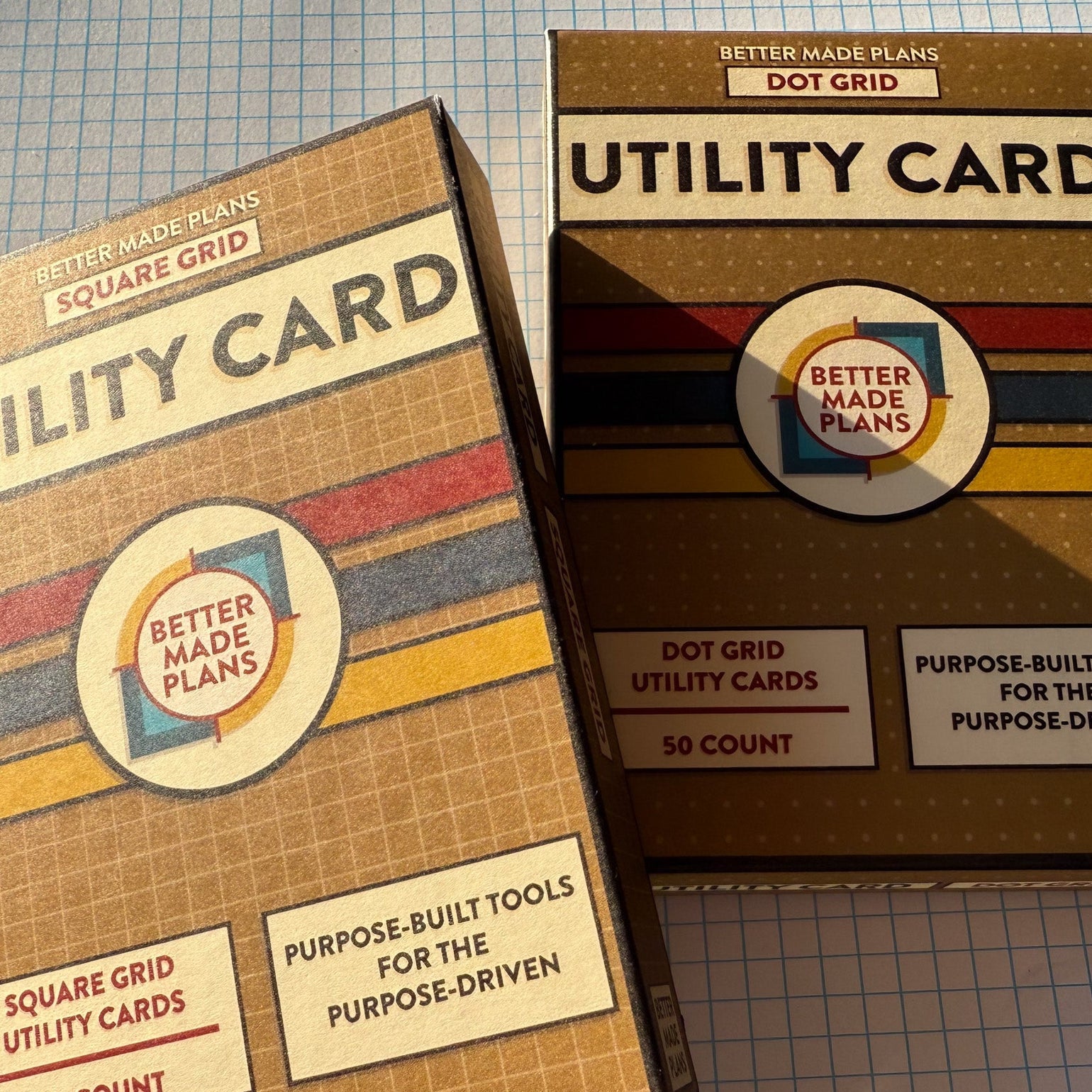 Packaging for Better Made Plans Utility Card Series Dot Grid and Square Grid cards laying on a graph paper background.