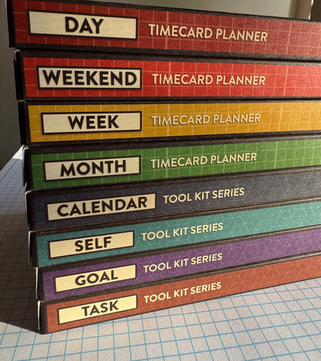 Stack of Better Made Plans planning card boxes on graph paper.