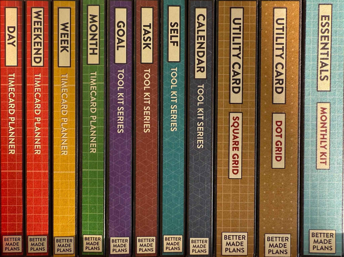 Brightly colored spines of the different Better Made Plans planning card packages.