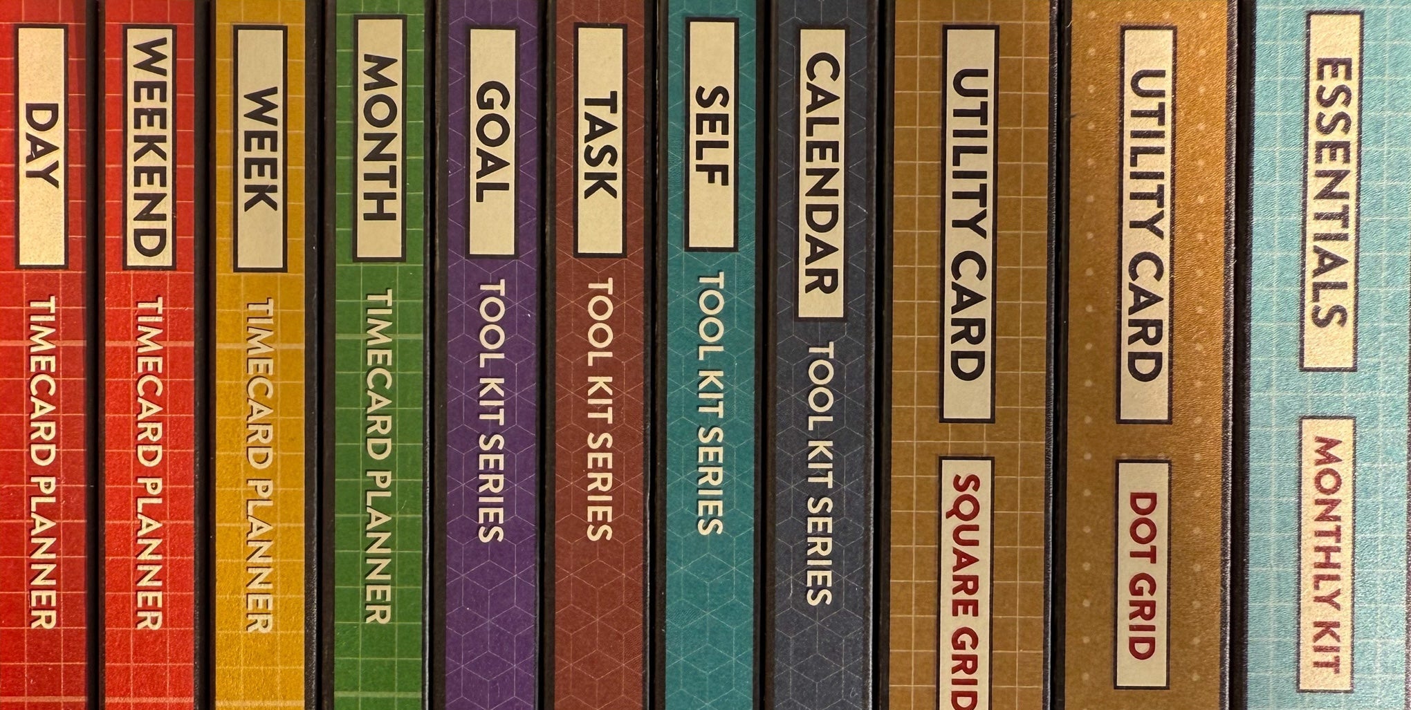Colorful spines of packaging for Better Made Plans planning cards listing the names of cards in each box and the series.
