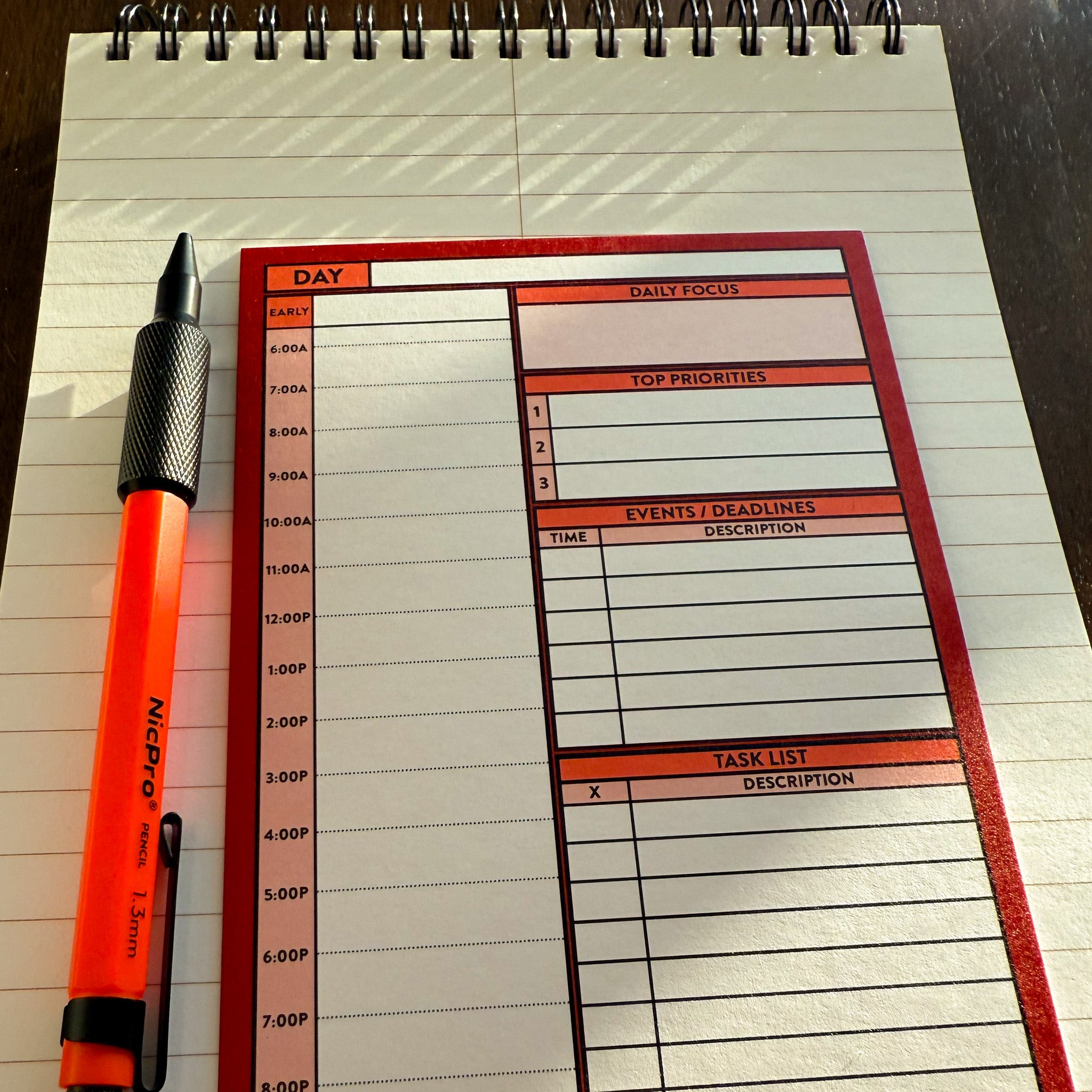 Better Made Plans Day planning card laying next a pencil on a wirebound steno pad.