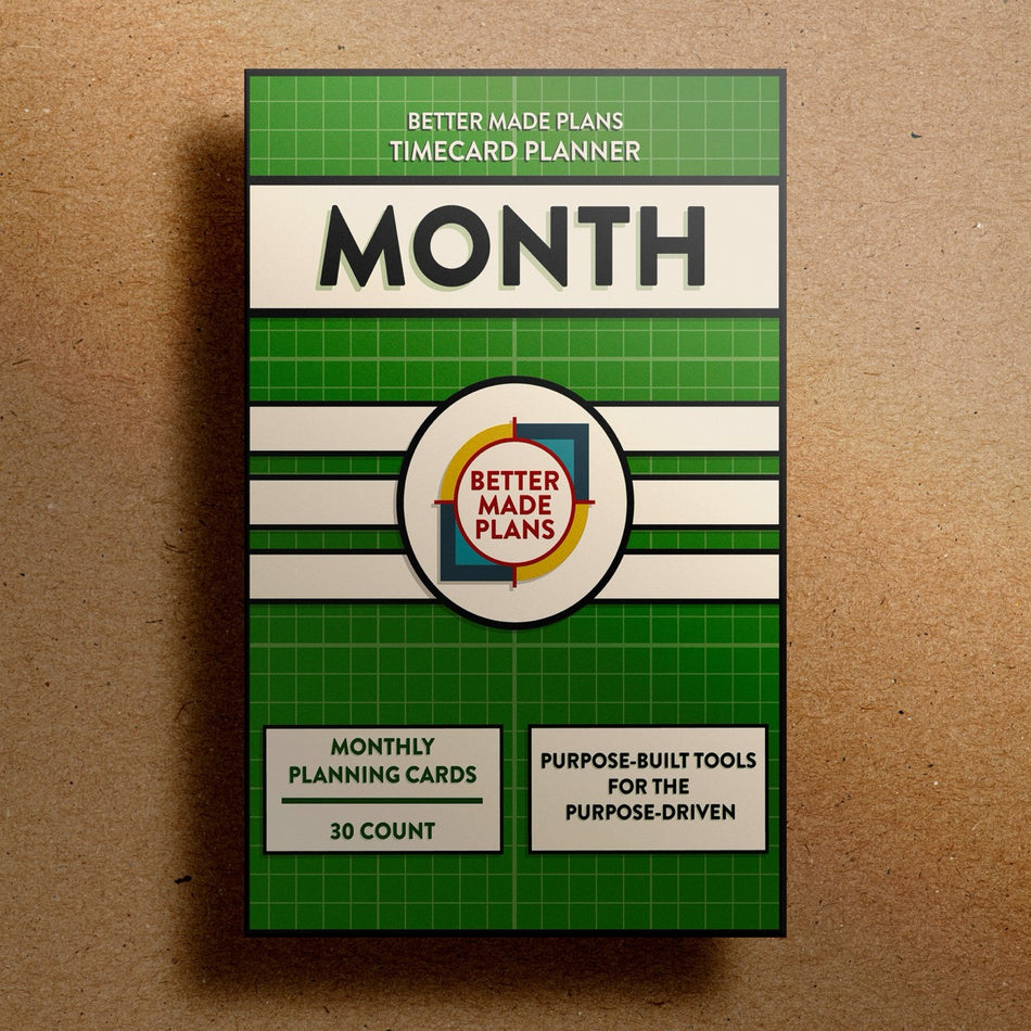 Better Made Plans Timecard Series Month Edition planner packaging on a brown background.