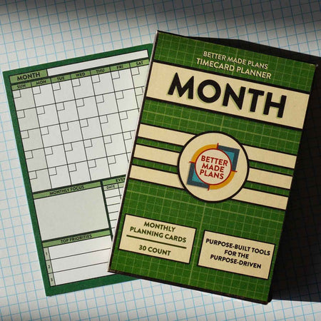 Better Made Plans Month Planner planning card with packaging on grid background