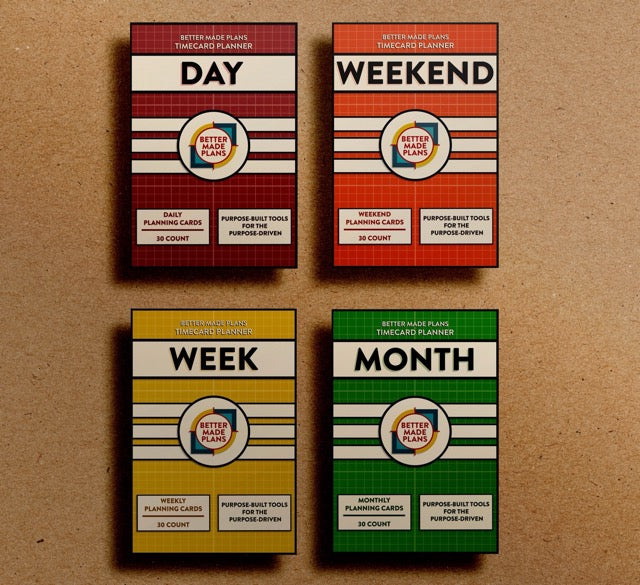 Packaging for Better Made Plans Timecard Series planning cards (Day, Weekend, Week, and Month versions) on a brown kraft paper background.