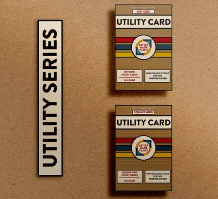 Packaging for Better Made Plans Dot Grid and Square Grid Utility Card Series planners laying on a brown paper background with a black-and-white label saying "Utility Series"